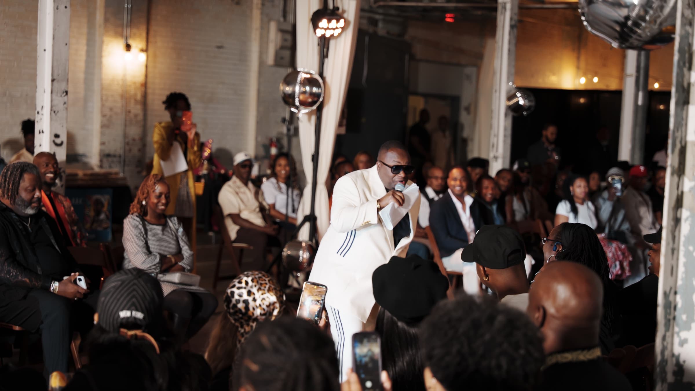 Cornell Lewis addressing a room at a Sharp Gentlemen Society production